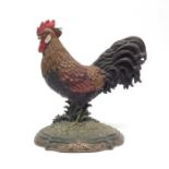 A cast metal doorstop in the form of a cockerel.