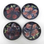Four Moorcroft circular pin dishes decorated with