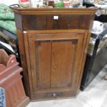 An oak and mahogany inlaid corner cupboard