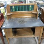 An Edwardian oak and tile backed washing stand