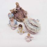Five porcelain pin cushion dolls, one seated with