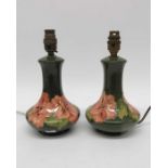 A pair of Moorcroft Hibiscus on green lamp bases,
