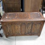 An oak blanket chest, fielded panelled lid above fo