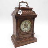 An Edwardian oak cased mantel clock, enamel dial f