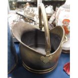 A brass coal scuttle, helmet form with swing over