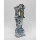 A 18th Century Delft mantel clock, in the form of