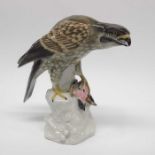 A Sitzendorf figure of a bird of prey with bird on
