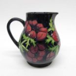 A Moorcroft Anemone on blue jug, baluster form, im