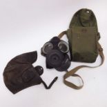 An Avon WWII gas mask with bag, and a leather flying cap. (2)