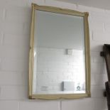 A bevelled gilt edged wall mirror