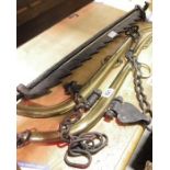Brass and wrought iron horse yoke and a black fire ratcheted suspension iron