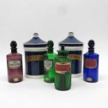 A set of three tinted glass apothecary bottles and