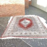 A large Persian style carpet, floral head and foli