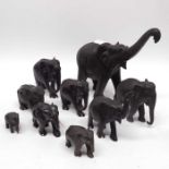 Ten ebonised carved elephants, together with two lacquered trays