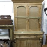A Victorian pine bookcase, twin arch glazed doors