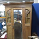 An oak single mirror door wardrobe, with fret carv