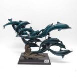 A SPI lacquered bronze sculpture of dolphins