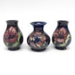 A pair of Moorcroft anemone pattern vases, baluste