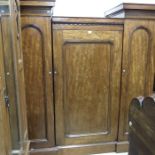 A mahogany sentry box wardrobe, the central fielde