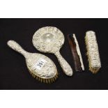 A silver mounted brush and mirror set, embossed wi