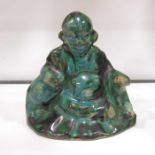 A Chinese Han Dynasty style seated figure, mottled