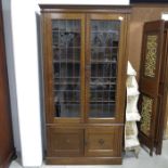 A 1920s oak and lead glazed bookcase cabinet, with