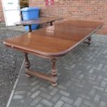 A Victorian extending dining table on trestle styl