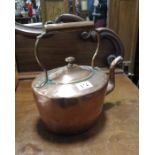 A hand raised copper kettle