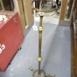 A brass adjustable lamp standard, on trefoil base