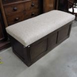 A three bay oak box settle with hinged upholstered lid