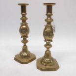 A pair of early 19th century brass candlesticks,