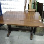 An oak drop flap trestle table