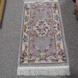 A Chinese Washed Rose design rug