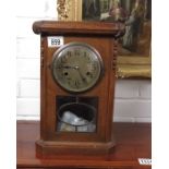 An oak cased mantel clock, stepped pediment and ch