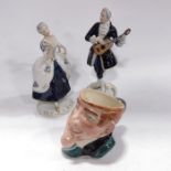 A pair of Royal Dux figures and a character jug