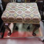 A tapestry topped stool on cabriole supports