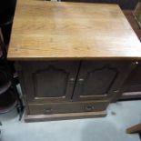 An oak television cabinet, two doors over single d