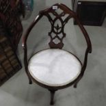 An Edwardian oval corner chair