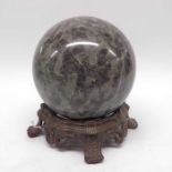 A marble orb on cast metal stand. with pierced fri
