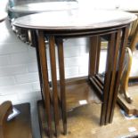 A nest of three mahogany oval occasional tables on