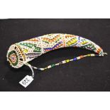 An African Zulu horn, within a beadwork case