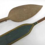 Two wooden paddles, including an oar and a spear