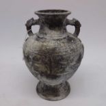 An Archaistic style cast metal footed vase, twin h