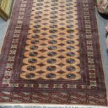 A finely woven Tribal style Persian rug, peach and