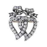 A late Victorian silver and gold, diamond double witches heart and bow brooch