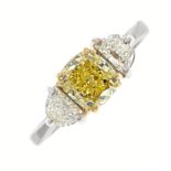 An 18ct gold Fancy Intense Yellow diamond and diamond three-stone ring