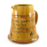 C H Brannam for Liberty and Co., an art pottery motto jug