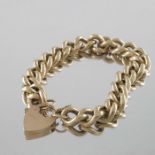 A 9 carat gold lock and heavy chain link bracelet,