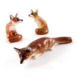 Charles Noke for Royal Doulton, three fox figures, HN147 and HN130