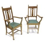 A pair of Arts and Crafts oak armchairs, in the style of Shapland and Petter